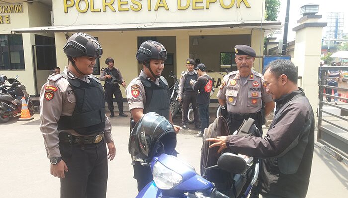 Kasat Sabara Polrestro Depok Kompol Subandi bersama anggota memeriksa tamu yang membuat laporan. (angga)